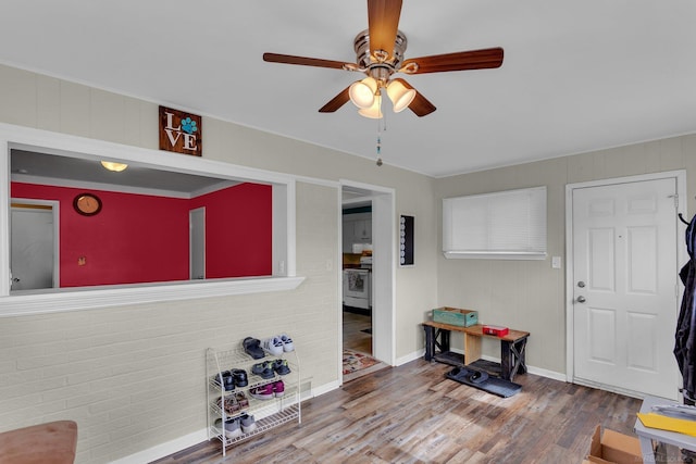 interior space featuring ceiling fan, wood finished floors, and baseboards