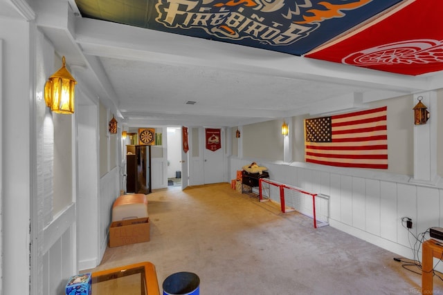 interior space with carpet floors and wainscoting