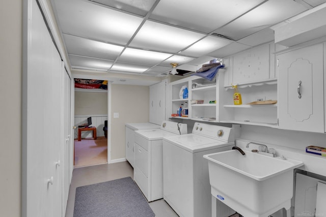 laundry area with washer and dryer, cabinet space, and a sink