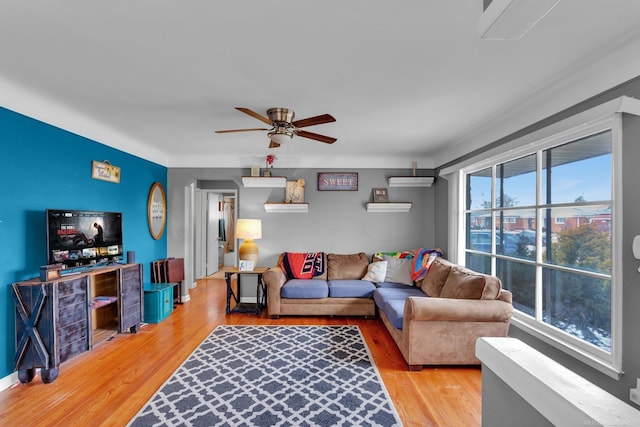 living area with light wood-type flooring and ceiling fan