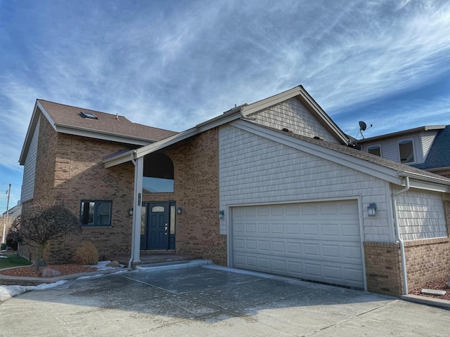 view of front facade with a garage, concrete driveway, brick siding, and roof with shingles