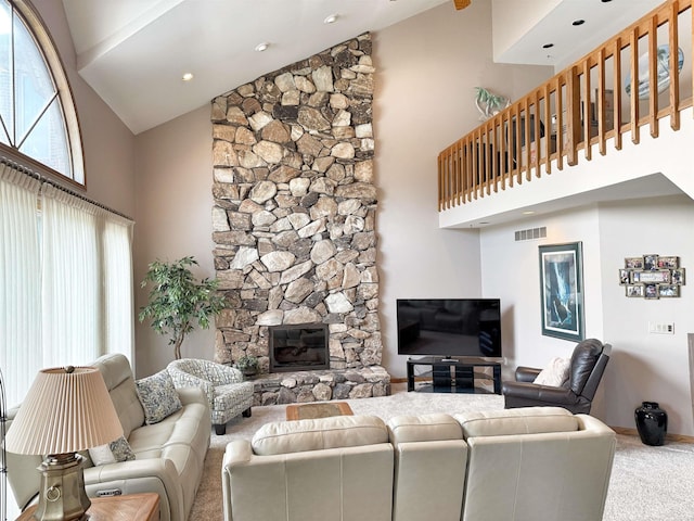 carpeted living room with a healthy amount of sunlight, high vaulted ceiling, a fireplace, and baseboards