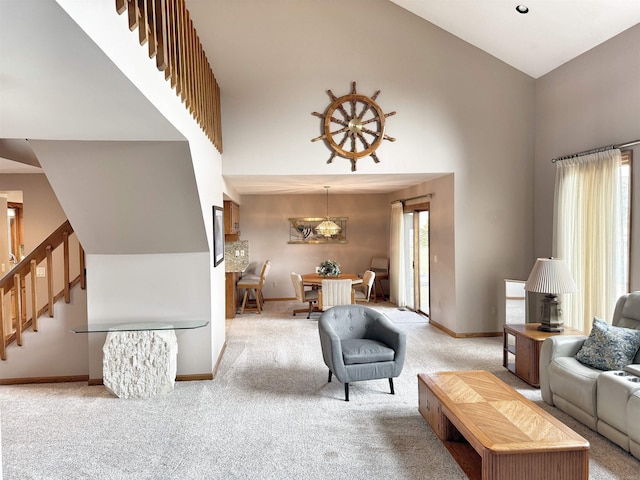 living room featuring light carpet, plenty of natural light, and a towering ceiling