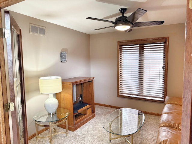 interior space featuring baseboards, visible vents, and a ceiling fan