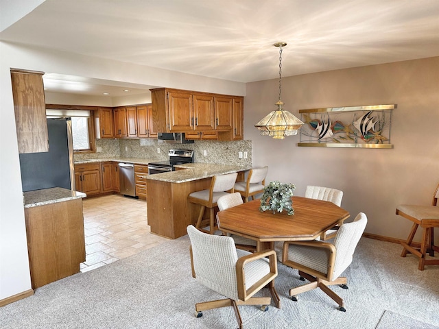 dining space with baseboards and light colored carpet