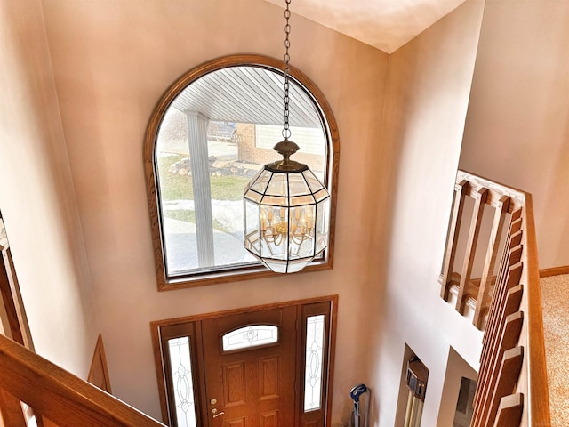 entryway featuring a towering ceiling