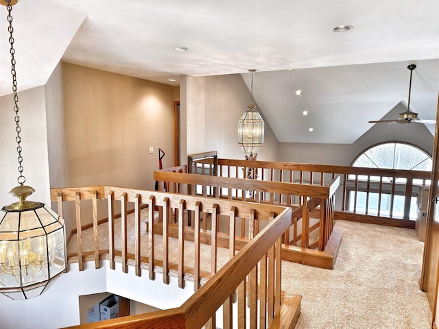 hall with vaulted ceiling, an upstairs landing, carpet floors, a chandelier, and recessed lighting