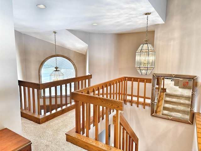 stairway with carpet, lofted ceiling, recessed lighting, and an inviting chandelier