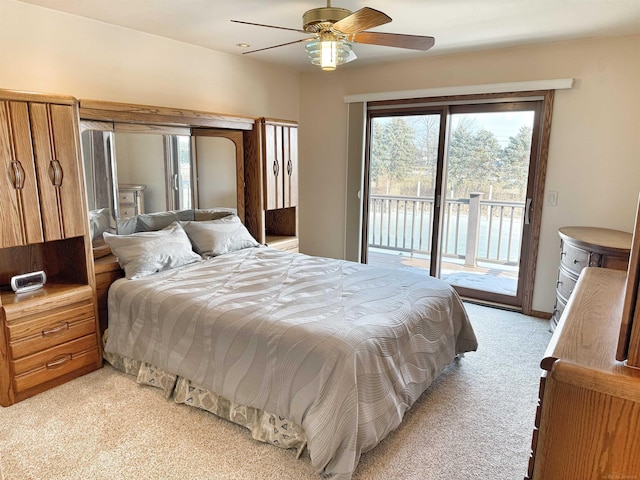 bedroom featuring access to outside, light colored carpet, and ceiling fan