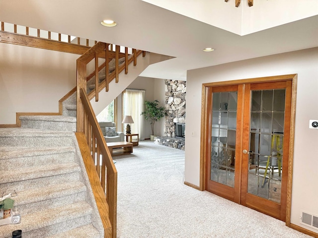 stairway with recessed lighting, carpet flooring, visible vents, and baseboards