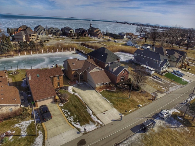 birds eye view of property with a water view and a residential view