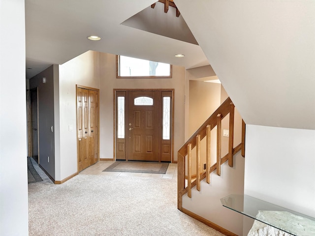 carpeted entrance foyer featuring stairs, recessed lighting, and baseboards