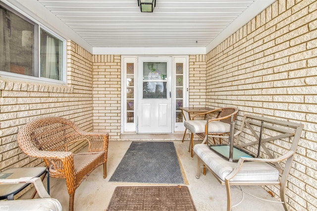 view of exterior entry with brick siding