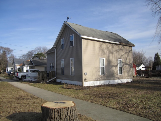 view of property exterior with a yard