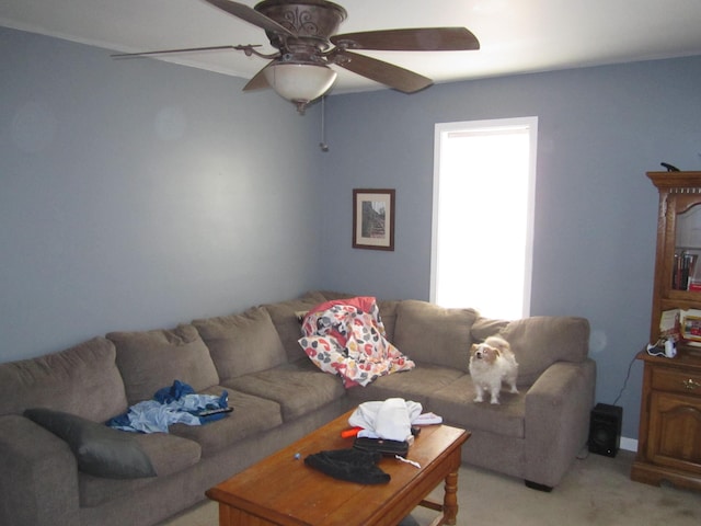 living area with light carpet and ceiling fan