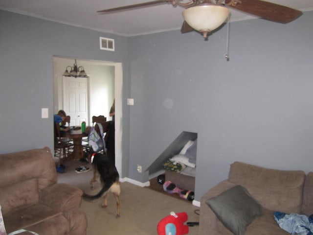 living room with carpet floors, visible vents, ceiling fan, and baseboards