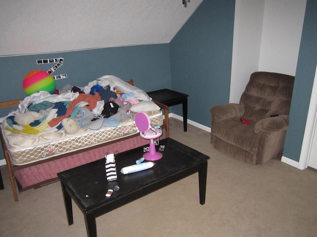 carpeted bedroom with vaulted ceiling and baseboards