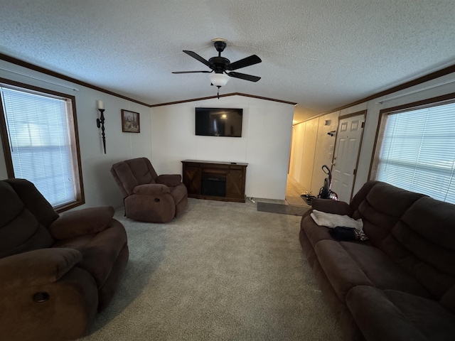 living room featuring carpet flooring, lofted ceiling, ornamental molding, and a textured ceiling