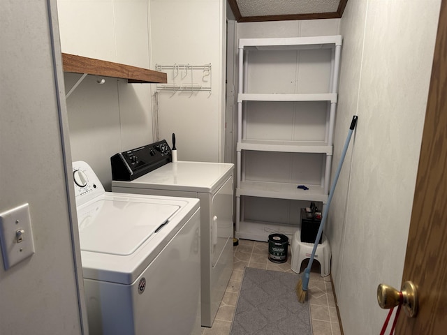 washroom with laundry area, light tile patterned floors, and washing machine and dryer