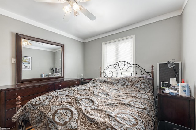 bedroom with ceiling fan and ornamental molding