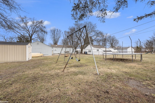 view of yard with a shed, a trampoline, a playground, and an outdoor structure