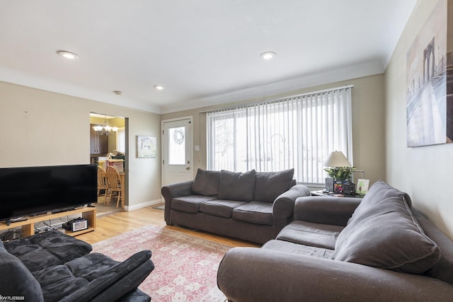 living room with baseboards, recessed lighting, wood finished floors, and a notable chandelier