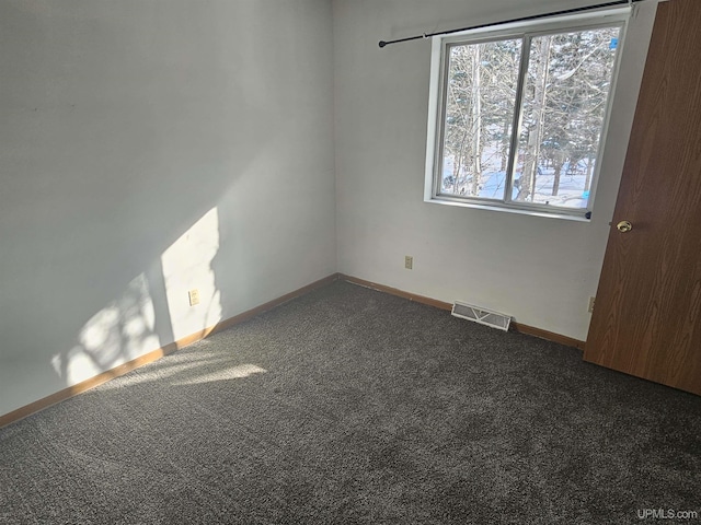 carpeted empty room with visible vents and baseboards