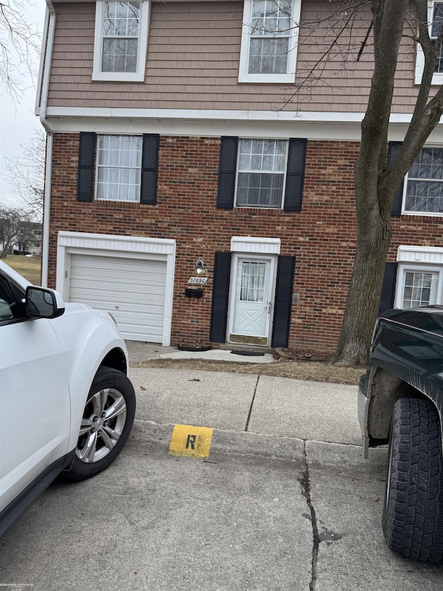 view of front of property with brick siding and an attached garage