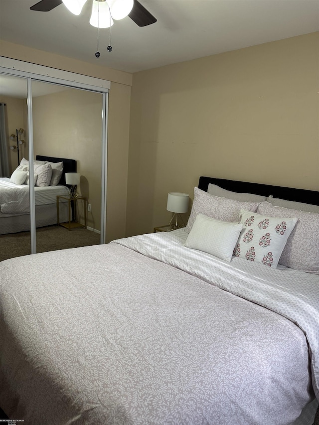 carpeted bedroom featuring a ceiling fan and a closet