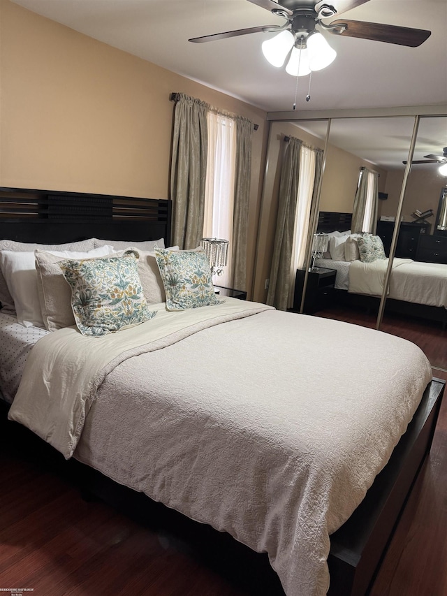 bedroom with a closet, ceiling fan, and wood finished floors