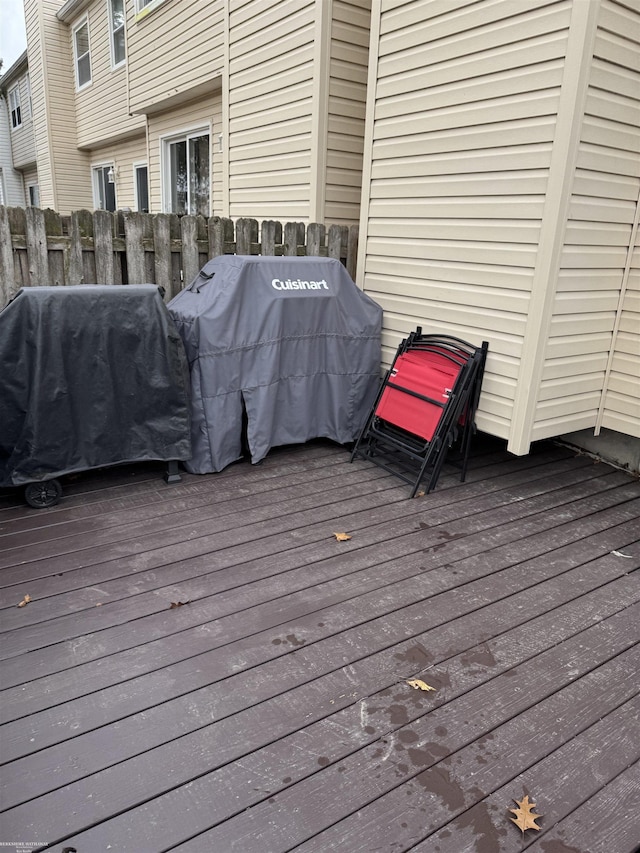 wooden terrace with grilling area and fence