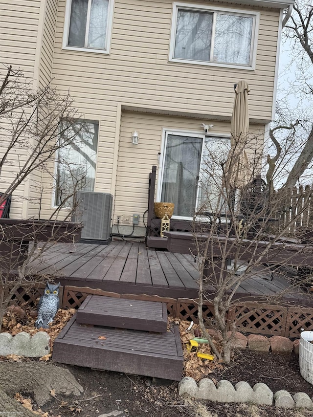 back of property with a deck and central AC unit