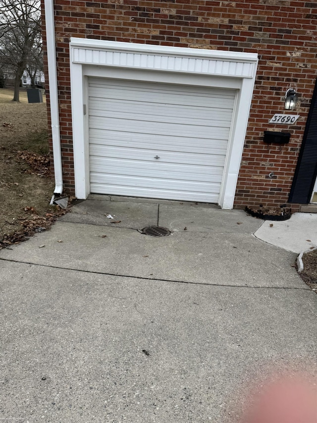 garage featuring concrete driveway