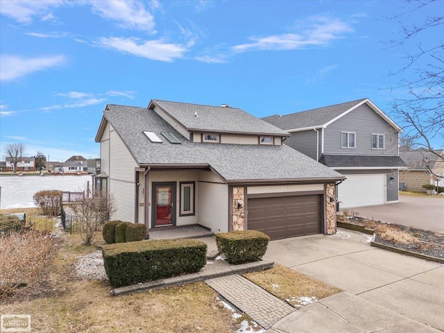 traditional-style home with a garage, stone siding, roof with shingles, and concrete driveway