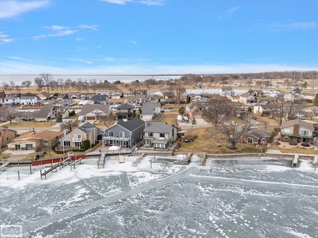 snowy aerial view with a residential view