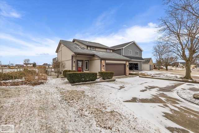 view of front of house with a garage and a shingled roof