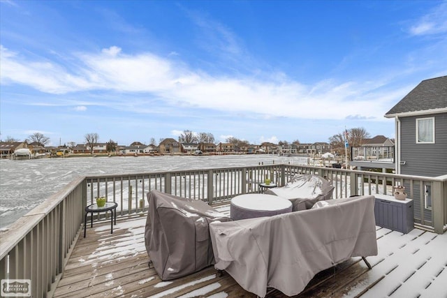 wooden terrace with a residential view and a grill