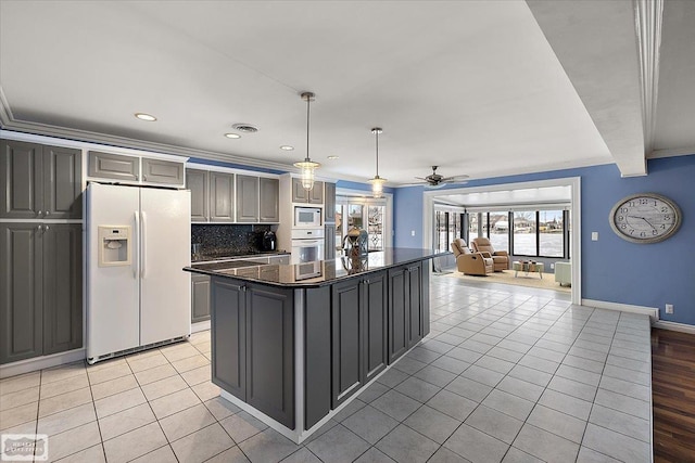 kitchen with light tile patterned flooring, white appliances, visible vents, open floor plan, and backsplash