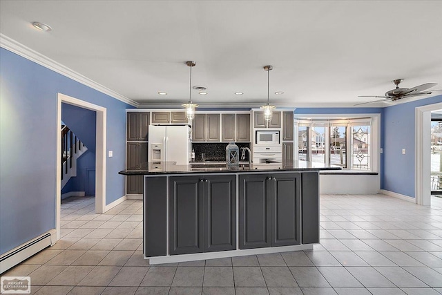 kitchen featuring a baseboard heating unit, white appliances, dark countertops, and light tile patterned flooring