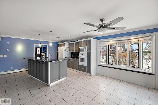 kitchen featuring dark countertops, white appliances, visible vents, and light tile patterned flooring