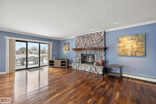 unfurnished living room with wood-type flooring, baseboards, crown molding, and a stone fireplace