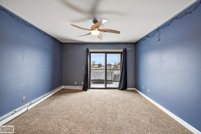 carpeted spare room featuring a baseboard heating unit, a ceiling fan, and baseboards