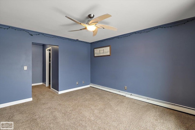 carpeted spare room with a baseboard radiator, baseboards, and a ceiling fan