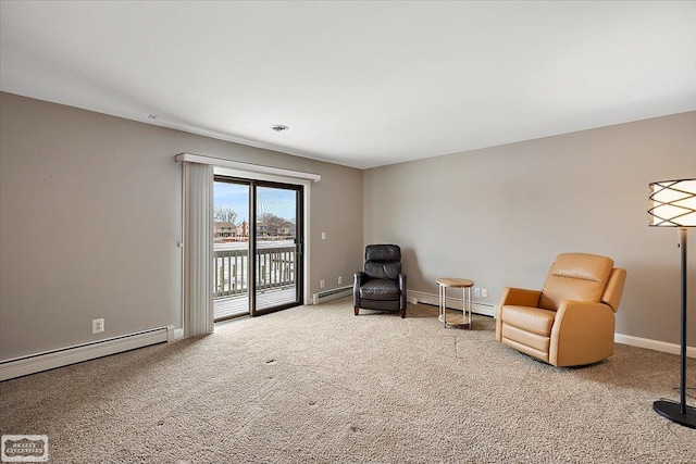 living area featuring a baseboard heating unit, carpet, and baseboards