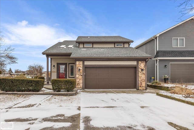 view of front of house featuring a garage, stone siding, and a shingled roof