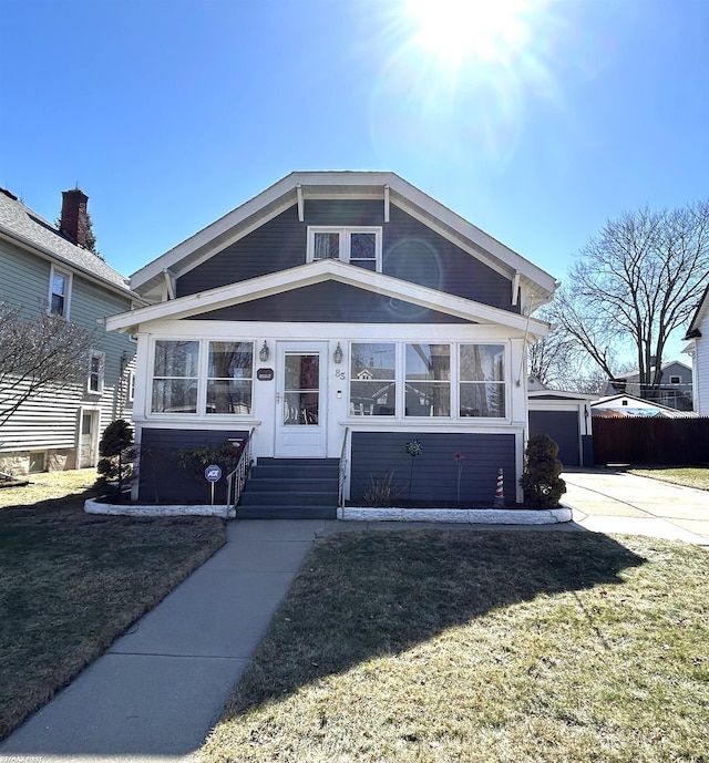 bungalow-style home featuring entry steps and a front yard