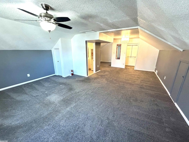 bonus room with baseboards, a textured ceiling, and lofted ceiling