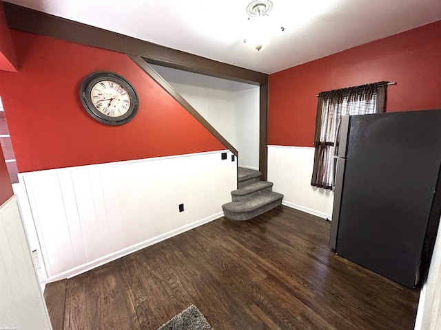 unfurnished dining area with stairs and wood finished floors