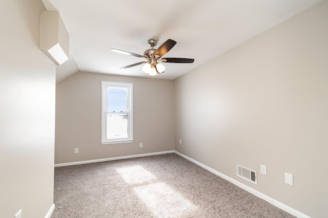 spare room with carpet floors, baseboards, visible vents, and a ceiling fan