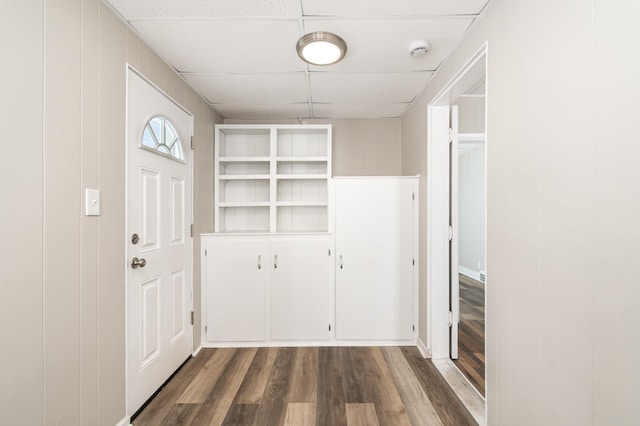 entrance foyer featuring dark wood finished floors and a paneled ceiling